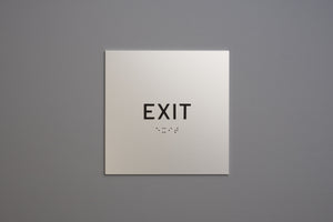 Exit sign on a gray wall