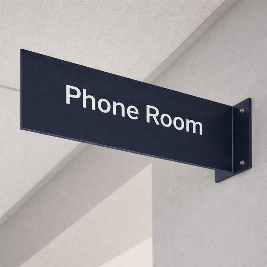 Sign pointing to 'Phone Room' on a wall corner