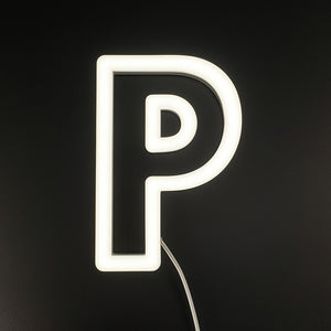 Neon light shaped like the letter 'P' on a black background
