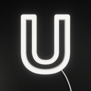 Neon light shaped like the letter 'U' on a black background