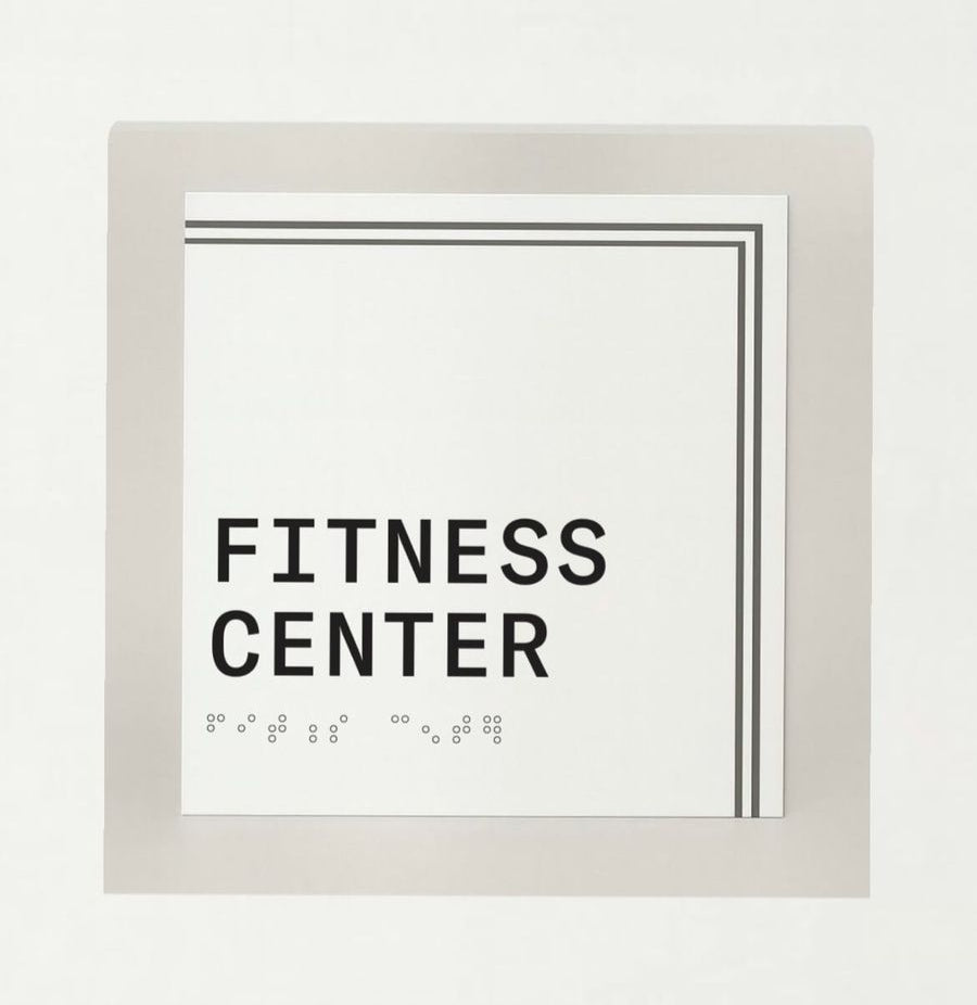 Framed sign with 'Fitness Center' text on a white background