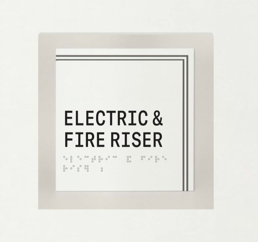 Framed sign with 'Electric & Fire Riser' text on a white background