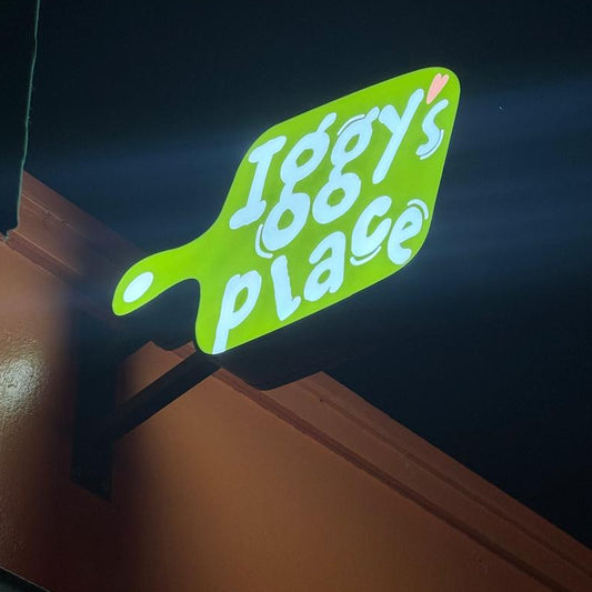 Neon sign with 'Iggy's Place' on a dark background